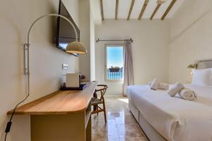 a bedroom with a bed and a desk next to a bed at Santa Barbara by Santas Hotels in Altea