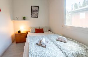 a bedroom with a bed with towels and a window at Hiška 231, 2 karti za Terme 3000, Moravske Toplice in Moravske-Toplice