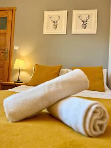 a towel laying on top of two beds at Willa Maya in Karpacz