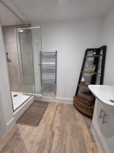 a bathroom with a shower and a sink at Littlestone Seaside Retreat in Littlestone-on-Sea