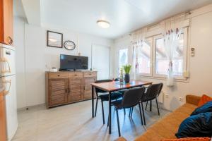 a kitchen and dining room with a table and chairs at Hiška 231, 2 karti za Terme 3000, Moravske Toplice in Moravske-Toplice +14 photos