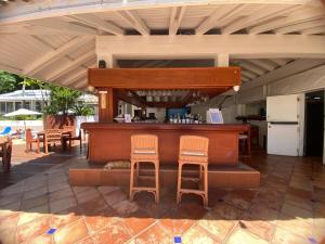 a bar on a patio with two stools at Oceanview large studio, pool, walk to Mullet Bay, Cupecoy Beach, walk to dining, free parking in Cupecoy