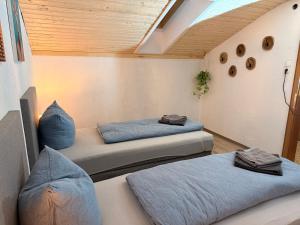 a room with two beds in a room at Haus Sauberbach in Jerzens