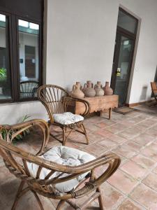 a patio with chairs and vases on a table at El Patio del Convento in Toledo