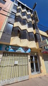 a building with a sign on the side of it at Hostal La Casa del Sol in Juliaca