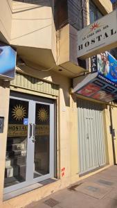 a store front with a glass door on a building at Hostal La Casa del Sol in Juliaca