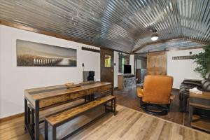 a living room with a table and a couch at Red River Gorge Creekside Cabin, Hot Tub, Shared Bathhouse in Stanton