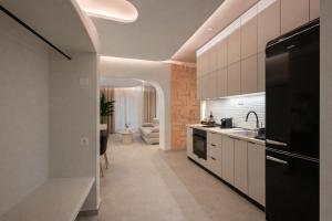 a kitchen with a sink and a stove at NOÈA Luxury Suites in Kavála