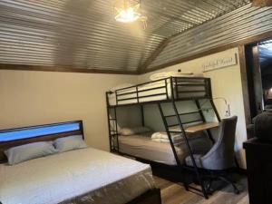 a bedroom with two bunk beds in a room at Red River Gorge Creekside Cabin, Hot Tub, Shared Bathhouse in Stanton
