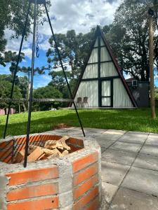 a house being constructed with a pile of wood at Chalé Rio das Pedras - Chalé 03 in Chapecó