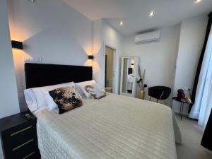 a bedroom with a large white bed with two pillows at LUSAIL 1ª línea playa ADULTS ONLY in Vinarós
