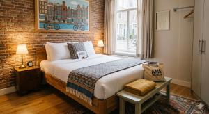 a bedroom with a bed and a brick wall at Hotel Taj Vista by Navodyans Near Taj Mahal in Agra
