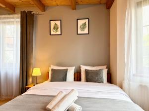 a bedroom with a large bed and a window at Willa Maya in Karpacz