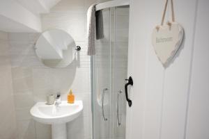 a white bathroom with a sink and a shower at 2 Bed in St Helens oc-76608 in Brading