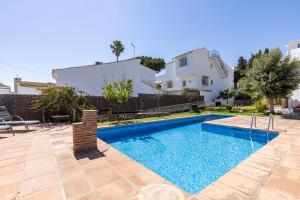 a swimming pool in the backyard of a house at Authentic apartment with pool and sea view in Estepona