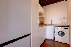 a kitchen with a washer and a washing machine at Authentic apartment with pool and sea view in Estepona