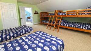 a bedroom with three bunk beds in a room at 1036 Maryland Ave in Cape May +16 photos