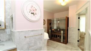 a bathroom with a shower and a plate on the wall at 12 Pearls in Cape May Point +25 photos