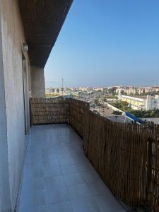 a balcony of a building with a view of a city at Appartement Moderne à coté de la plage - Essaouira in Essaouira +3 photos