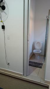 a bathroom door with a toilet in a room at Suites Aeroporto in Campinas +33 photos