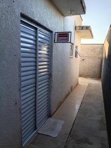 an open door in a hallway of a building at Suites Aeroporto in Campinas