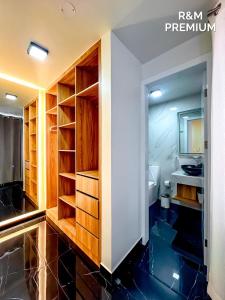 a bathroom with wooden cabinets and a sink at R&M Premium in Baños