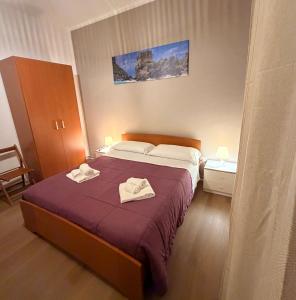 a bedroom with a bed with two towels on it at B&B Dora 2,0 in Praia a Mare