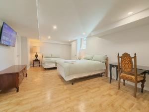 a bedroom with a bed and a couch and a table at Cozy Rooms in Bright Walkout Suite - Newly Renovated in 2026 in Richmond Hill