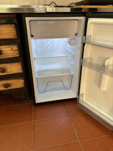 an empty refrigerator with its door open in a kitchen at Ciza - Departamento Temporario en Paraná in Paraná