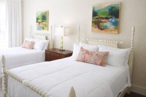 two white beds in a bedroom with white walls at The St Nicholas Hotel in Albany