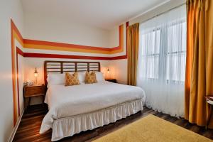 a bedroom with a bed and a large window at Urban Collective Boutique Hotel in Edwardsville