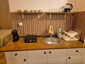 a bathroom counter with a sink and a phone at Casa Isabella in Xàtiva +7 photos