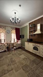 a living room with a table and a chandelier at Comfort Villa Sheki in Sheki