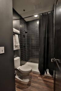 a bathroom with a toilet and a shower at Urban Collective Boutique Hotel in Edwardsville +30 photos