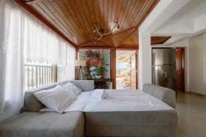 a bedroom with a large bed in front of a window at Skyloft - Rooftop Jacuzzi & Sea View - Central Kos in Kos