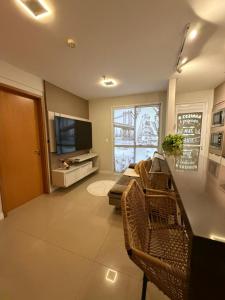 a living room with a couch and a television at JUPET Studio in Brasília