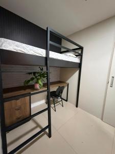 a bedroom with a desk and a bunk bed at JUPET Studio in Brasília
