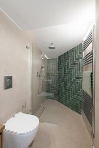 a bathroom with a toilet and a shower at Skyloft - Rooftop Jacuzzi & Sea View - Central Kos in Kos +10 photos