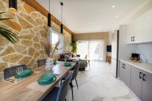 a kitchen and living room with a table and chairs at Villa Renata in Kontokali