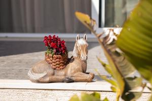 a wooden statue of a horse with a pineapple at Villa Renata in Kontokali