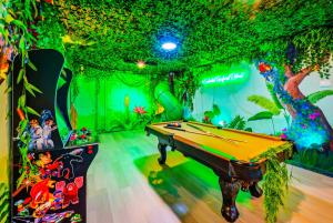 a game room with a pool table and a tree at Windsor Resort Private Pool & Theater Game Room in Davenport