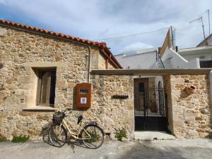 a bike parked outside of a stone building at ARETOUSA Private Village Suite in Sitia