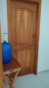 a wooden door with a blue container on a table at Galápagos Finch Apartment in Puerto Ayora +4 photos