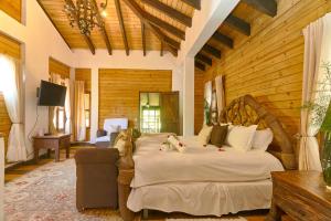 a bedroom with a large bed in a room at Villa ines-4X4only-Jarabacoa-View-Jacuzzi-5BR in Jarabacoa