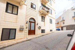 a building on the side of a street at Mandalay Cozy & Affordable Apartment with Patio in Mellieħa