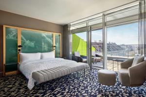 a bedroom with a bed and a large window at Le Méridien Vienna in Vienna +128 photos
