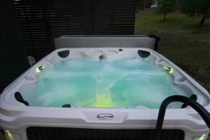 a jacuzzi tub with a hose in a yard at Yosemite Outpost in Oakhurst