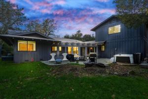 a large house with a patio and a backyard at Yosemite Outpost in Oakhurst