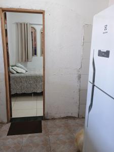 a kitchen with a mirror and a bed in a room at Casa da nicinha in Vitória