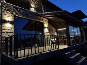 a house with a balcony with lights on it at Guest houses Forte in Tsigov Chark